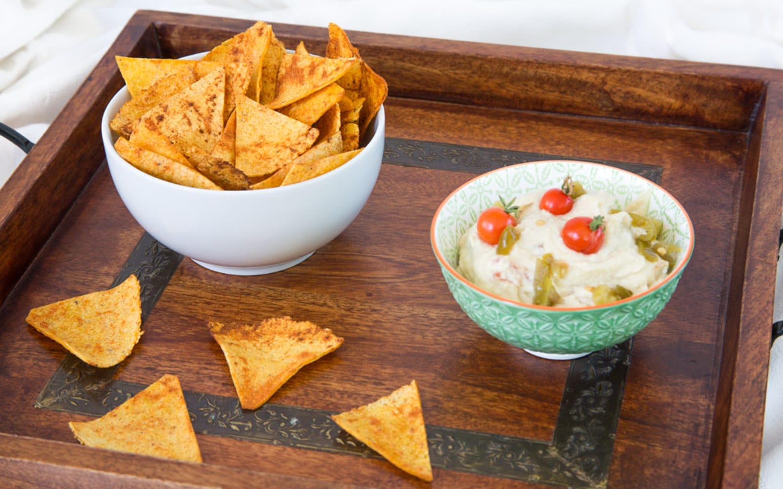 Vegan Gluten-Free Oil-Free Chili Lime Spiked Corn Chips in a dipping sauce