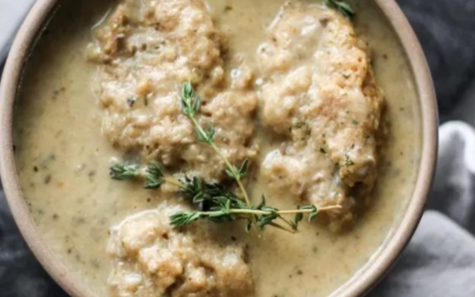Vegan Creamy Mushroom and Dumpling Soup Topped with thyme