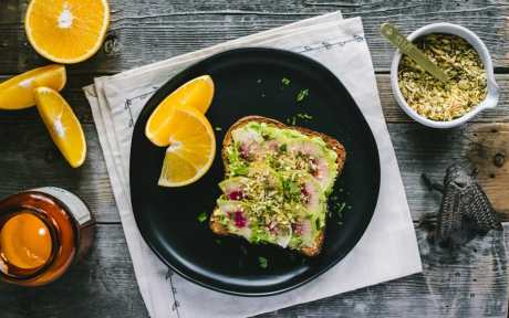 vegan gluten-free Winter Avocado Toast with Cheezy Pumpkin Seed Sprinkle with watermelon radishes and oranges