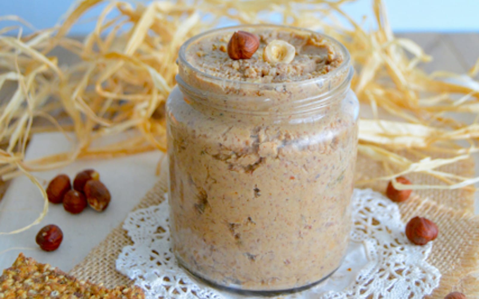 Vegan Savory Chestnut Spread with Hazelnuts in a jar topped with nuts