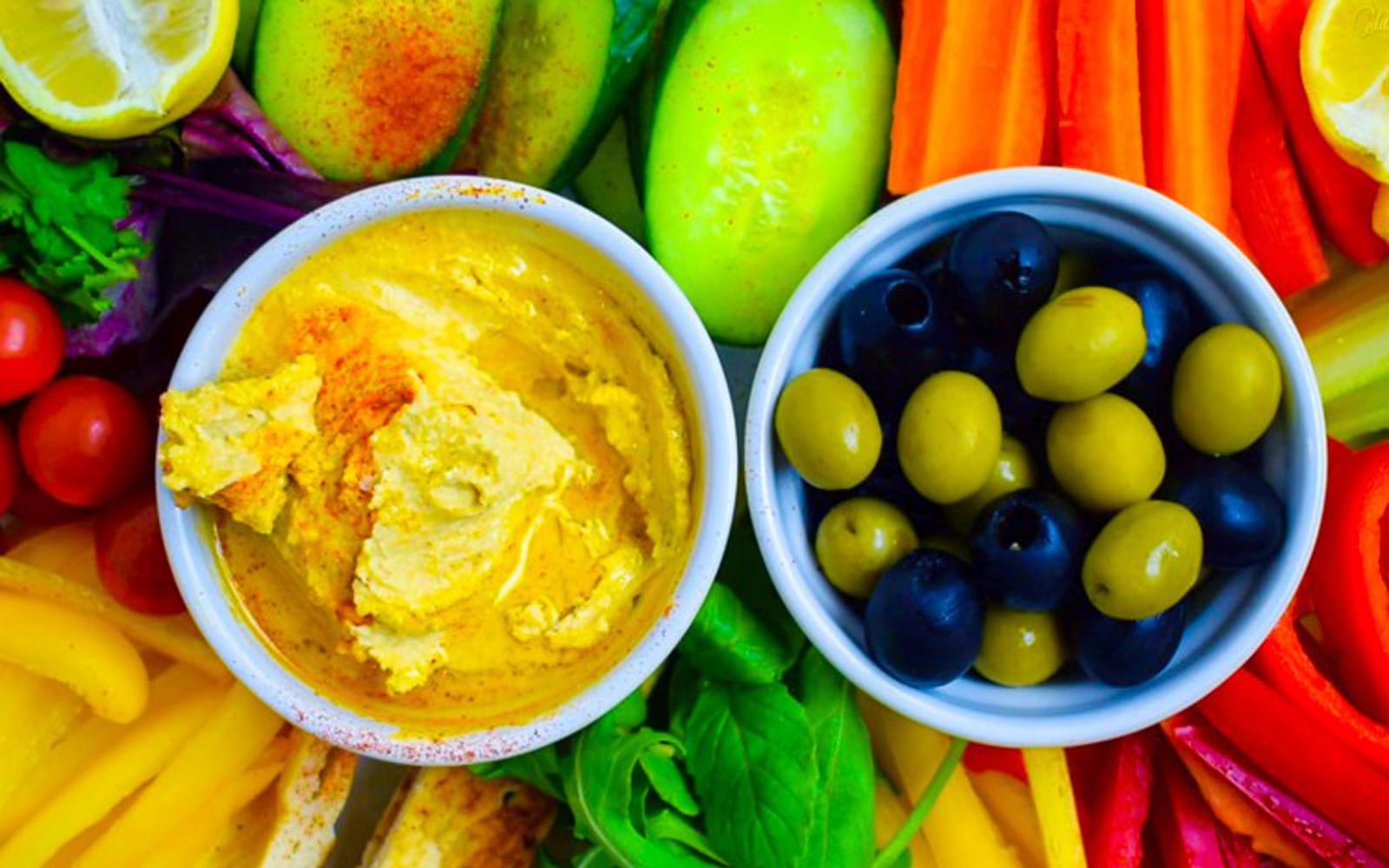 Vegan Gluten-Free Roasted Garlic Hummus with fresh vegetables and olives