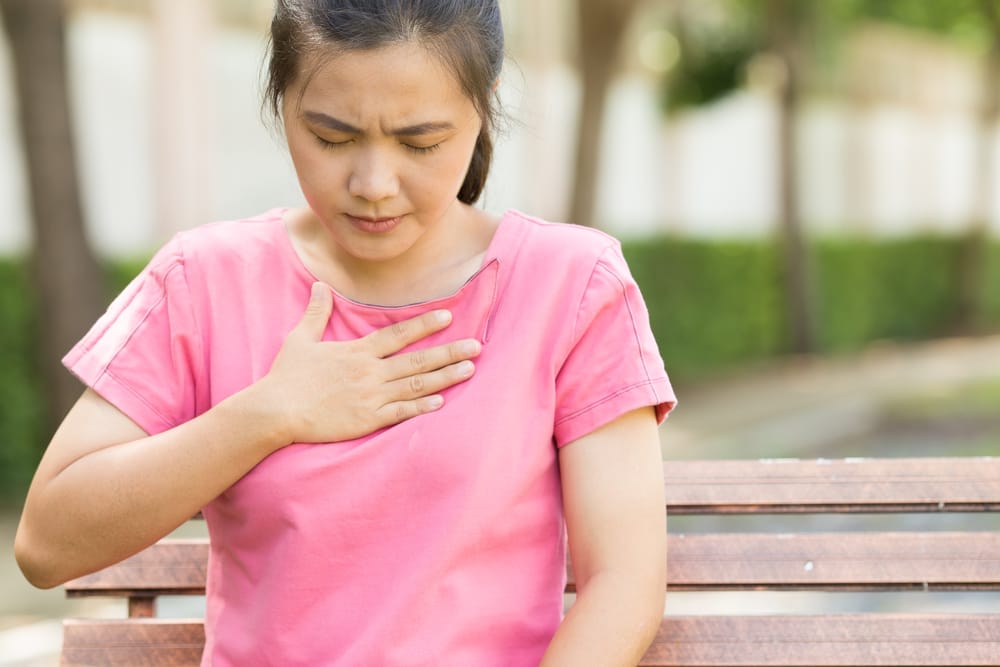 Woman putting hand on her chest