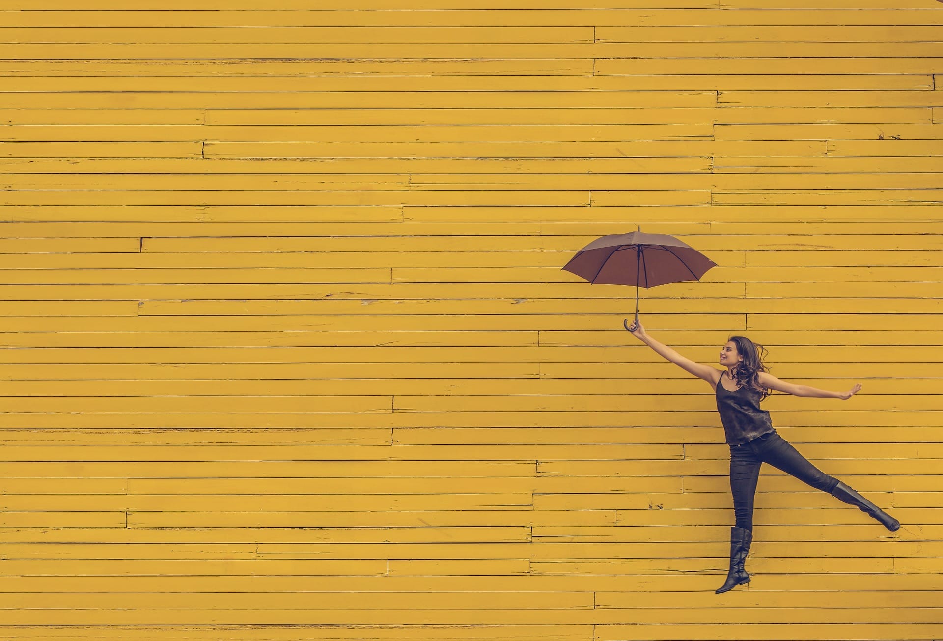 Girl happily holding an umbrella
