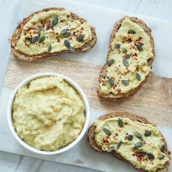Easy Avocado Hummus on toast on cutting board