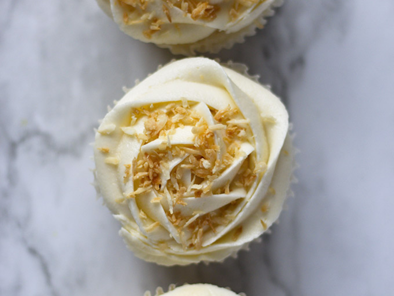 Vegan Coconut Cupcakes with Coconut Frosting and Coconut Shavings