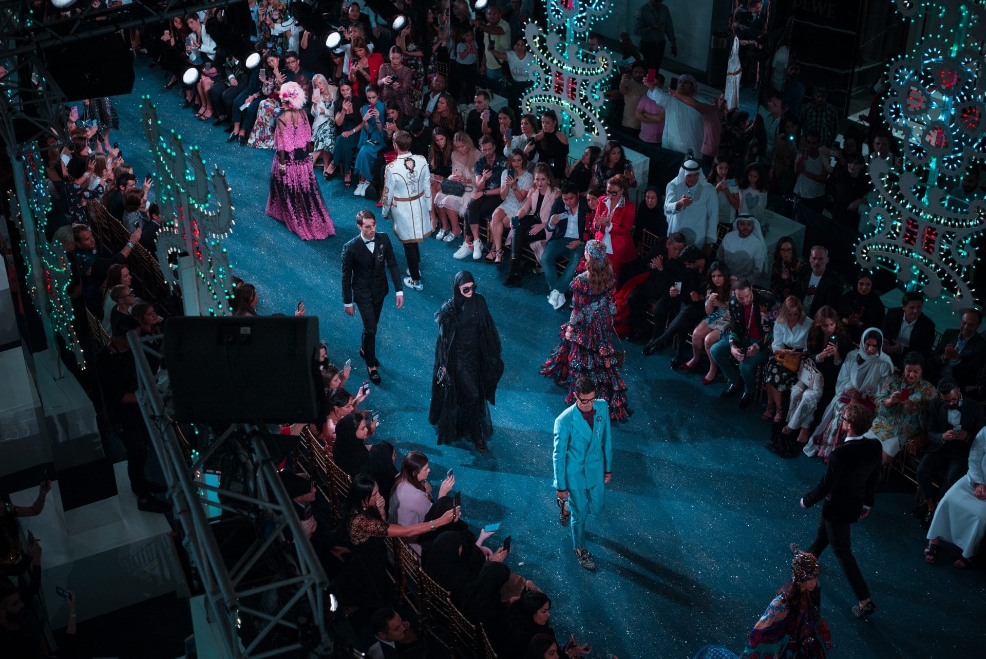 Models walking down the runway in fashion show