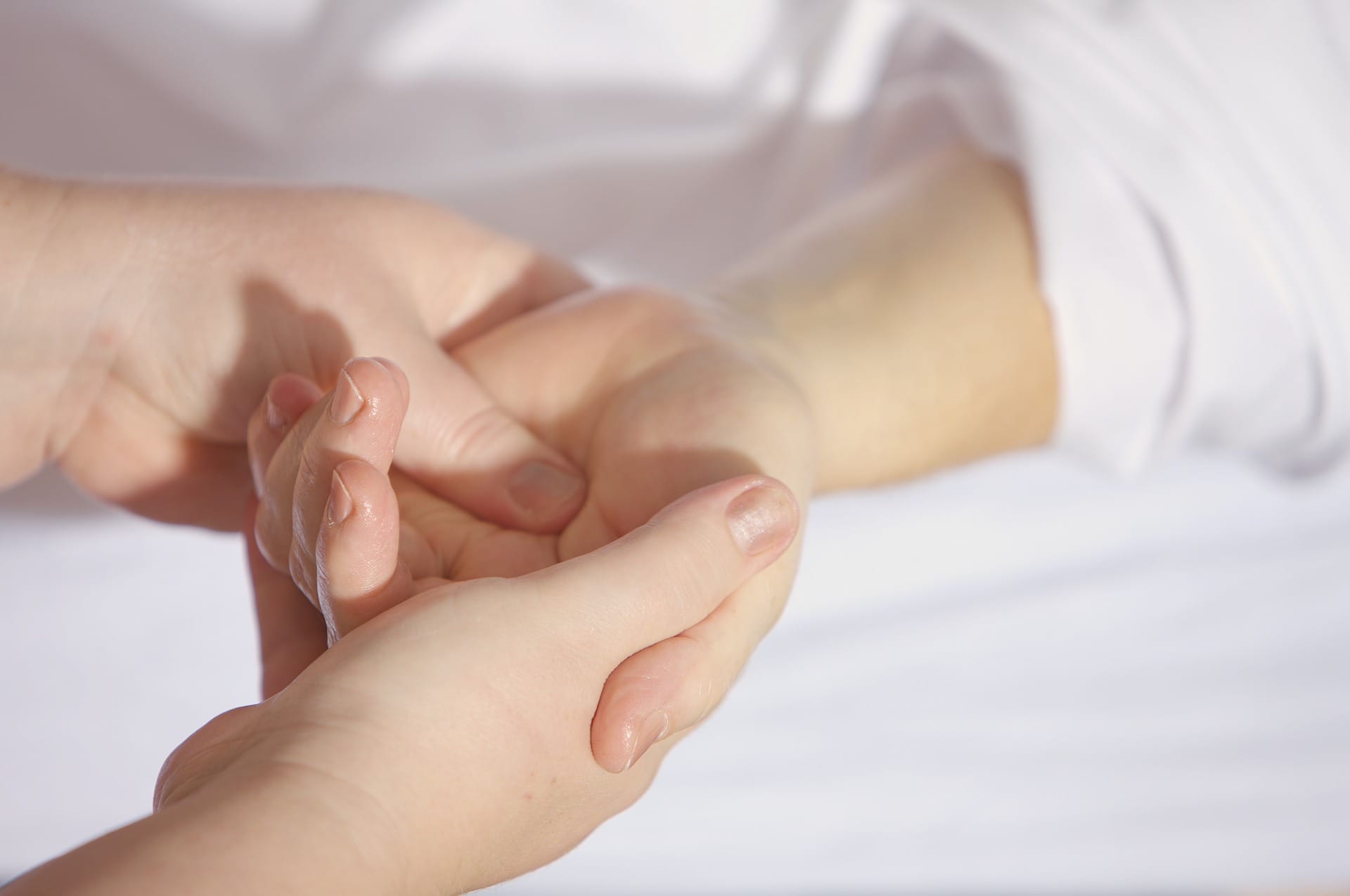 Someone practicing acupressure on a hand