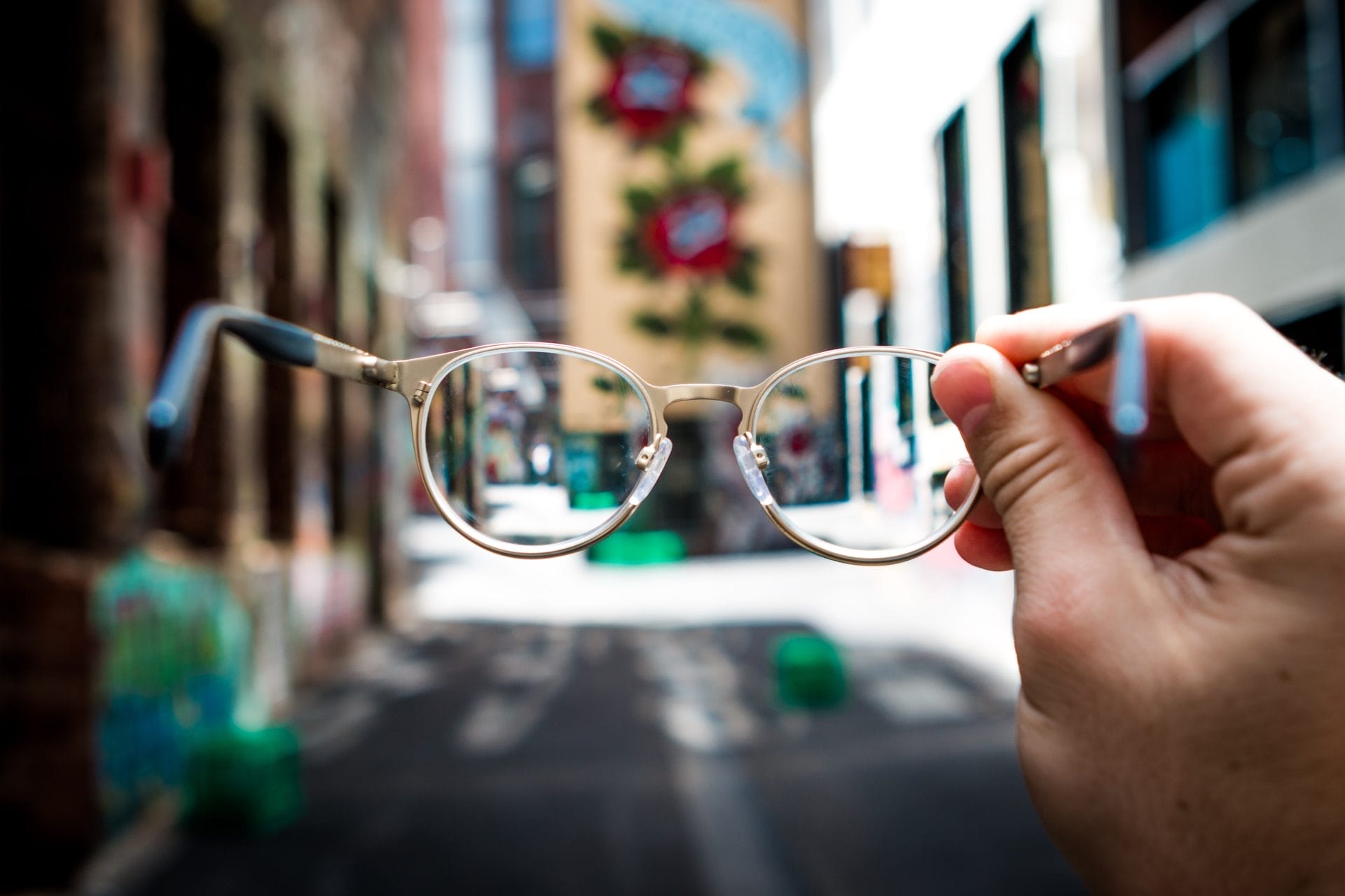 Eyeglasses Held Up Against Background