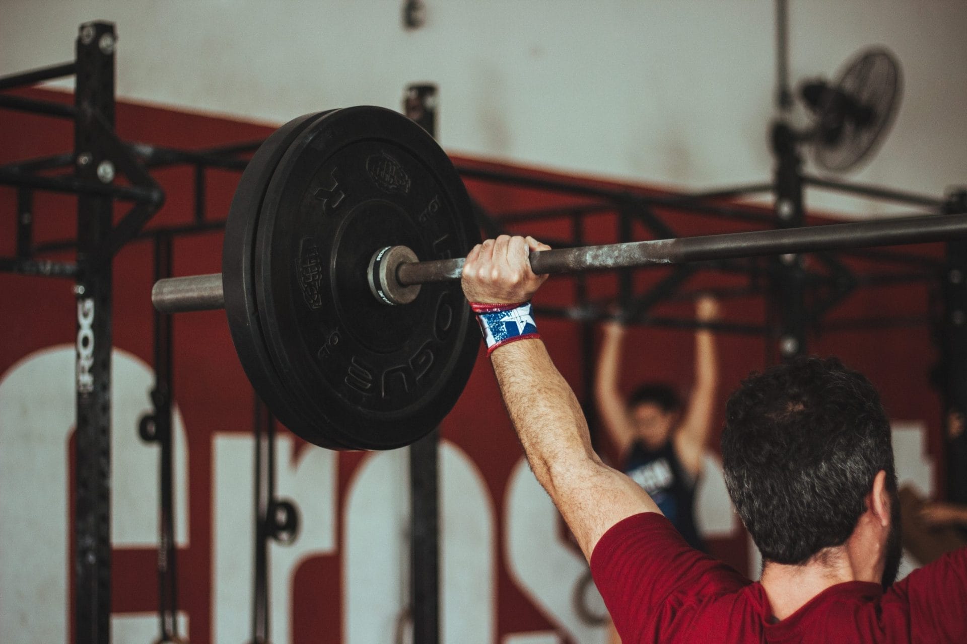 Man Lifting Barbell at the Gym