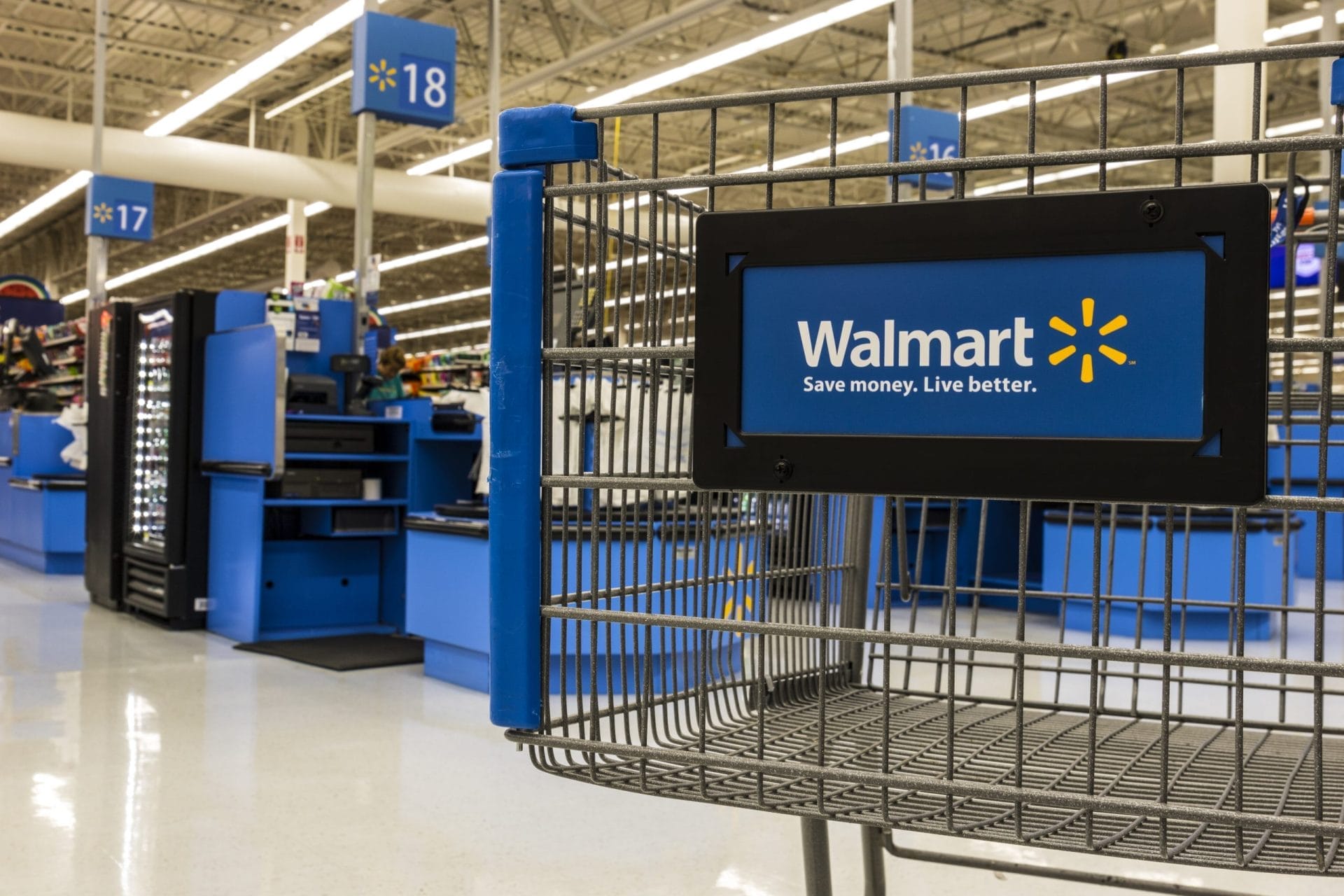 Walmart grocery cart with Walmart label in store.