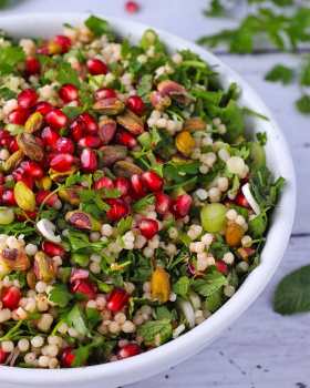 pomegranate-couscous-salad-in-white-bowl-close