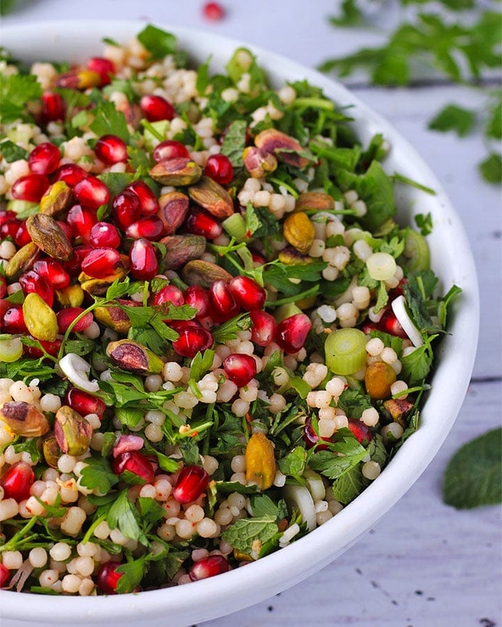 pomegranate-couscous-salad-in-white-bowl-close
