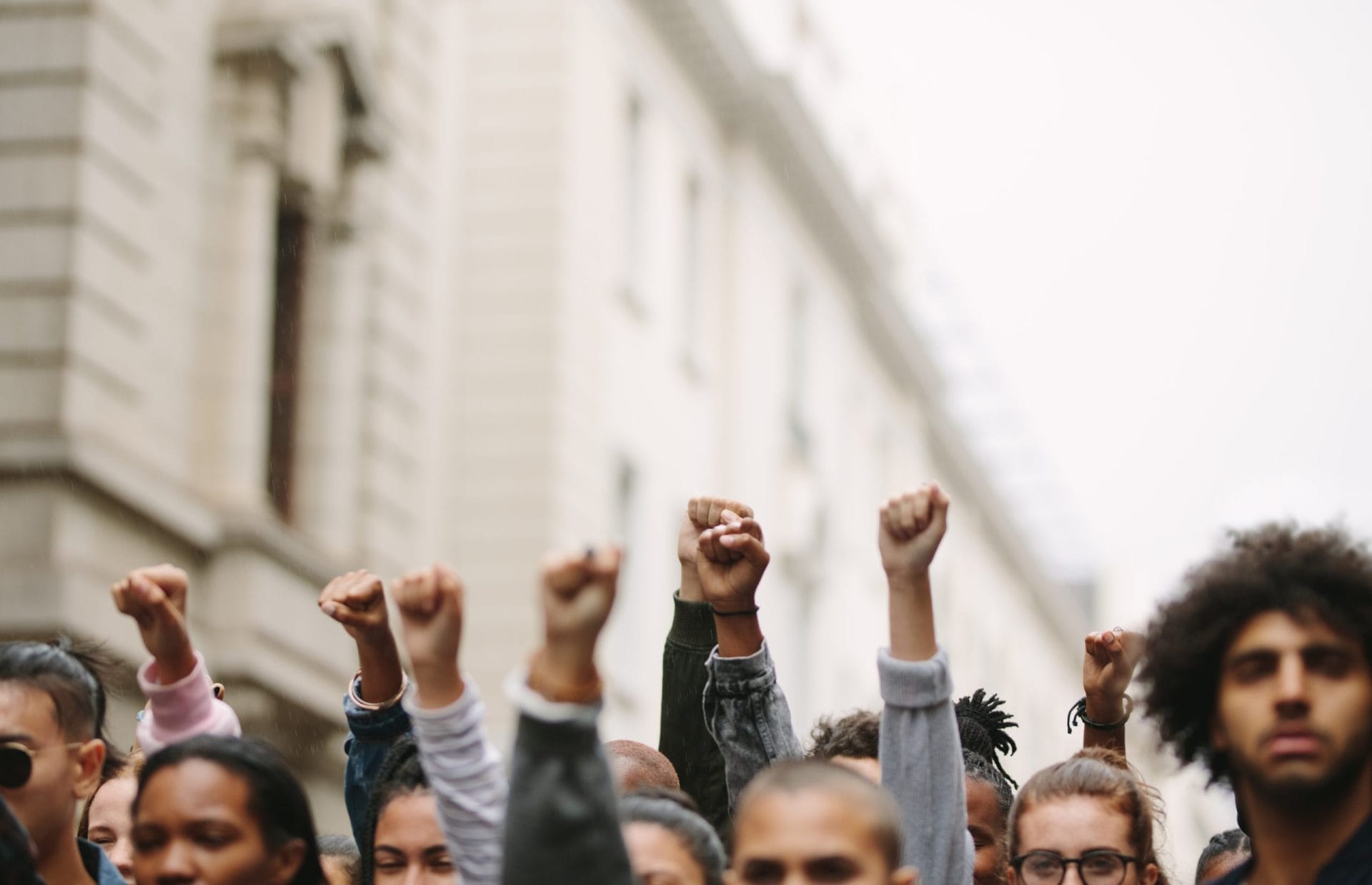 People holding their fists towards the sky