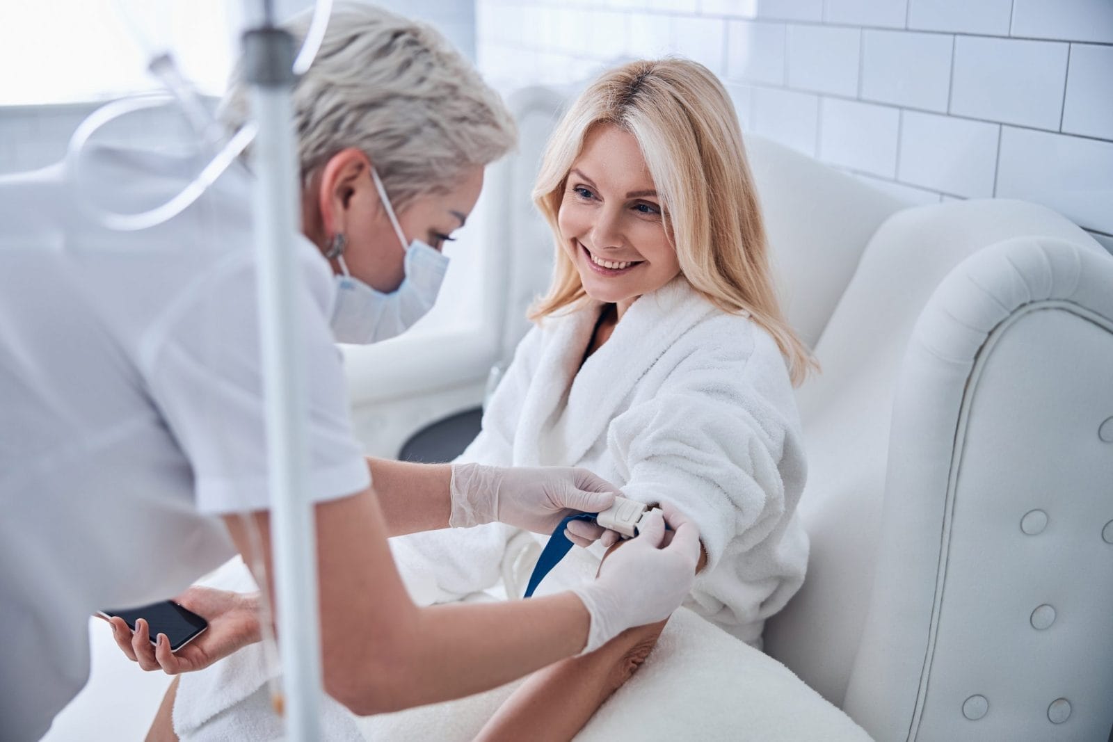 Woman sitting in a white chair with a doctor