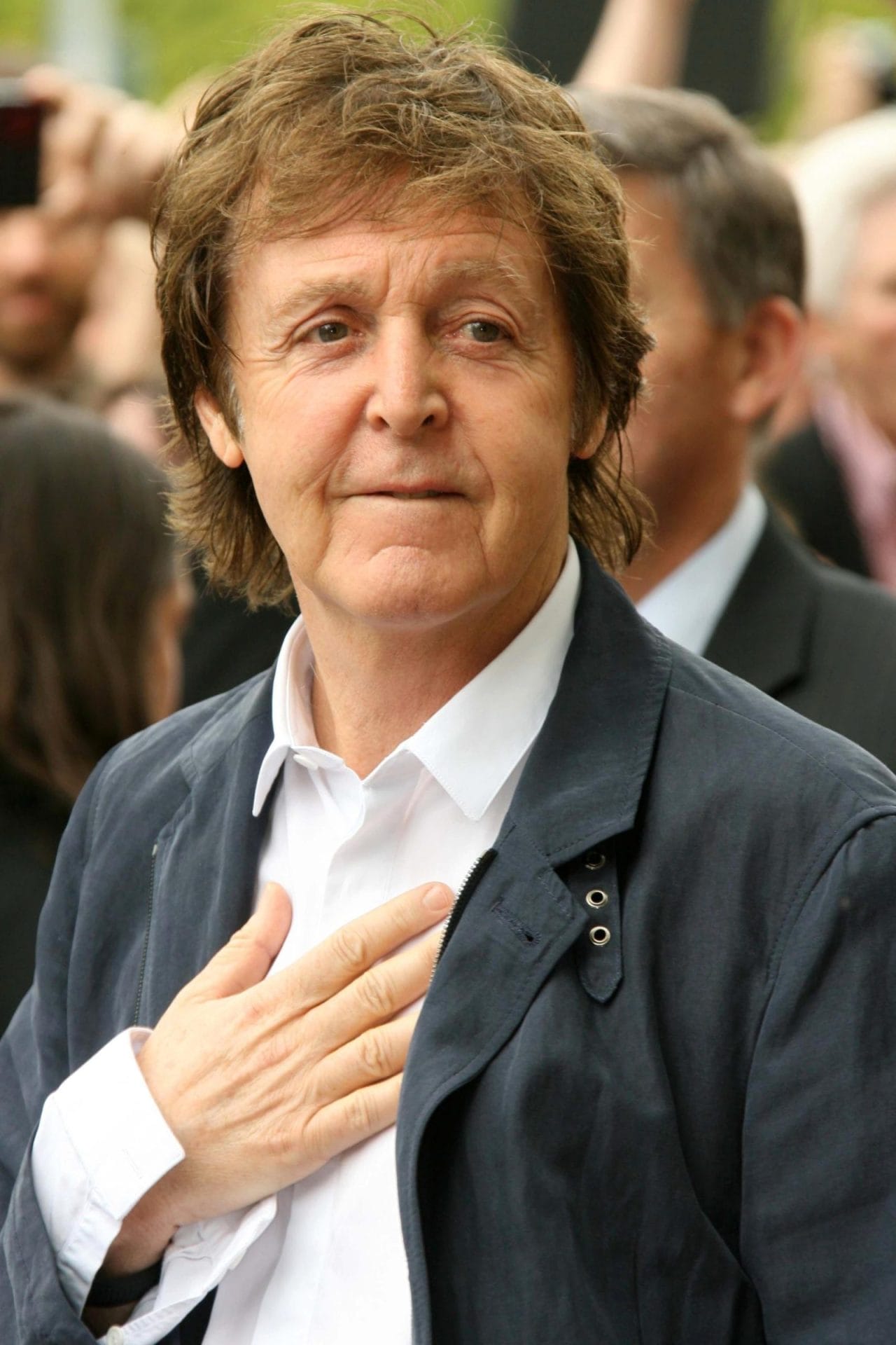 Paul Mccartney holding hand to heart