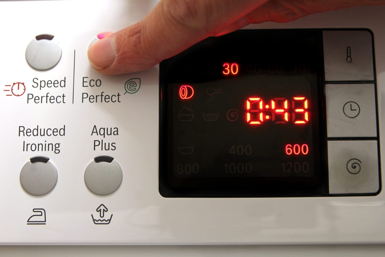 Finger pushing button on washing machine