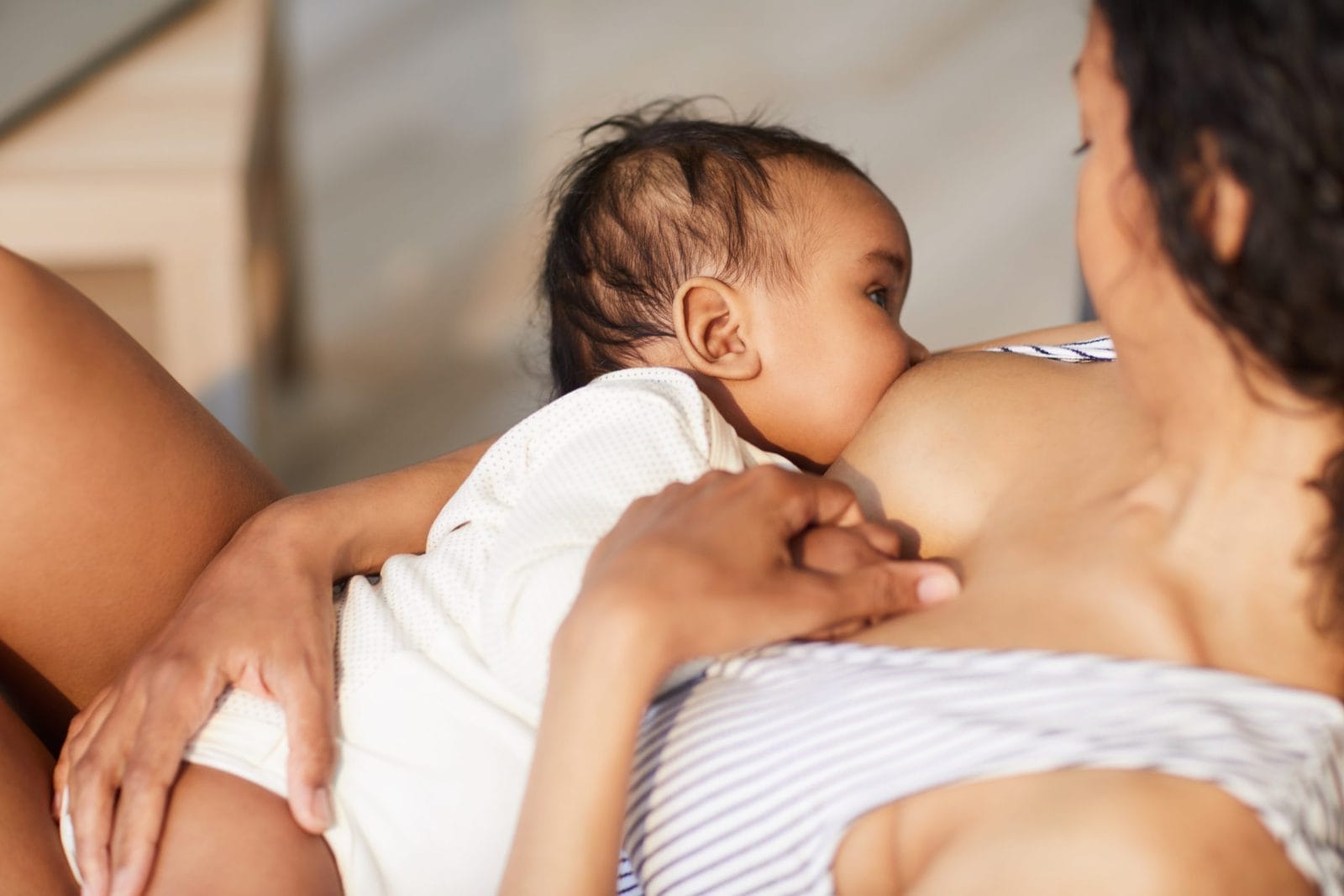 Mother feeding baby breast milk