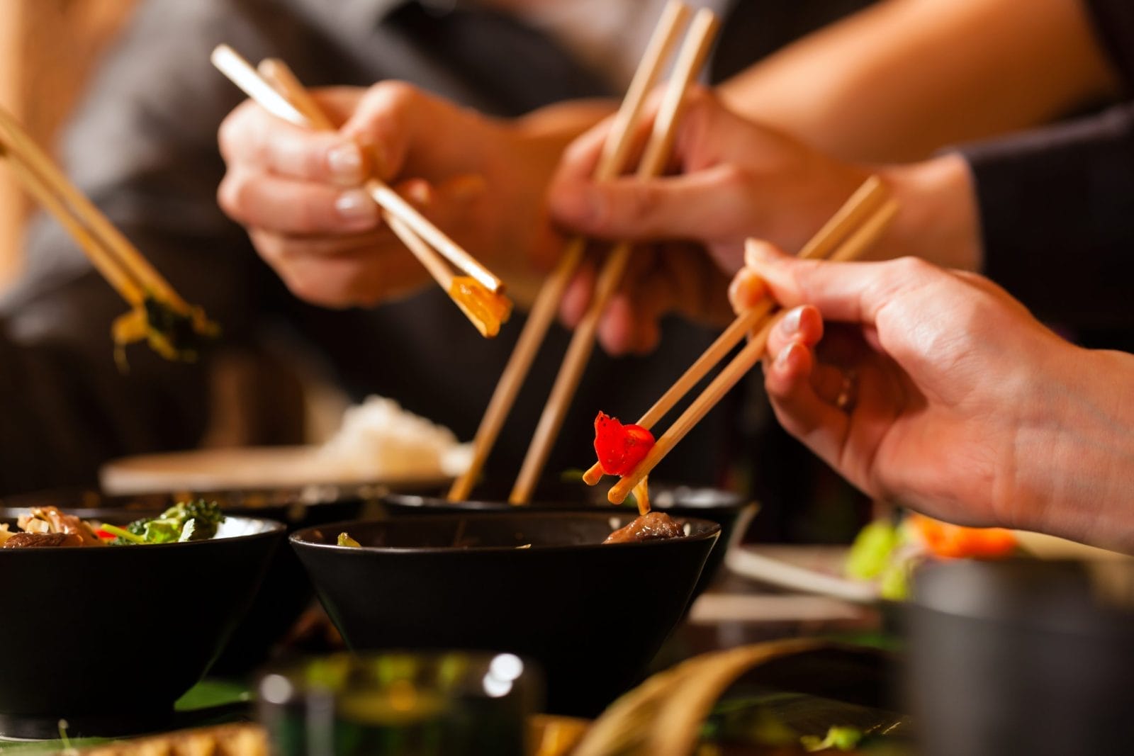 Young people eating in a Thai restaurant