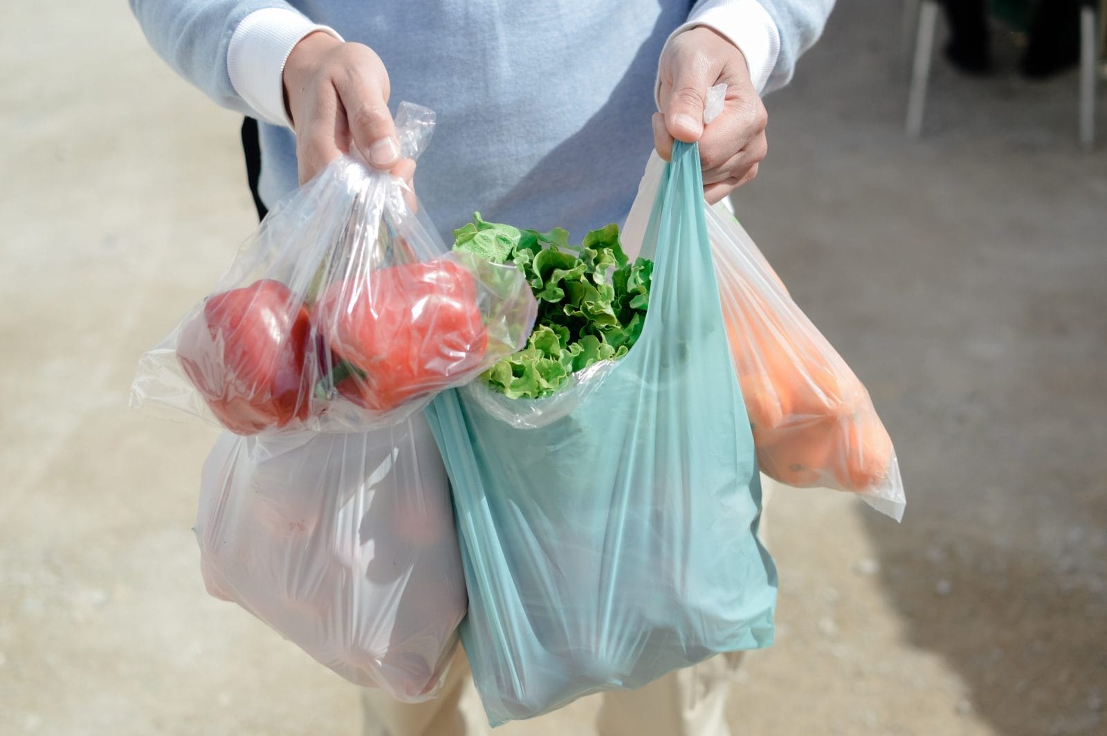 Close up on person buyer hold groceries in bags
