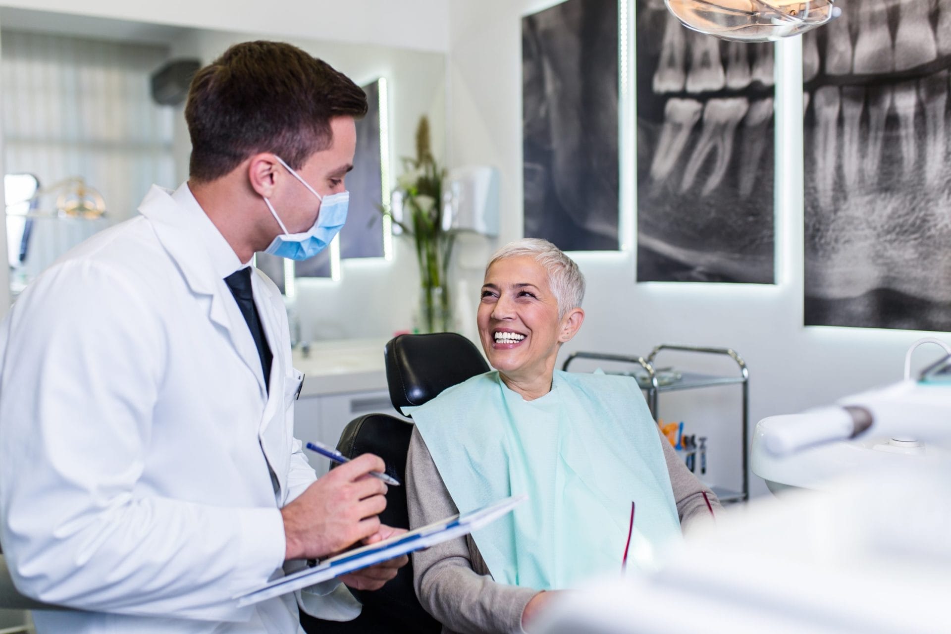 Woman patient sitting next to dentist in office