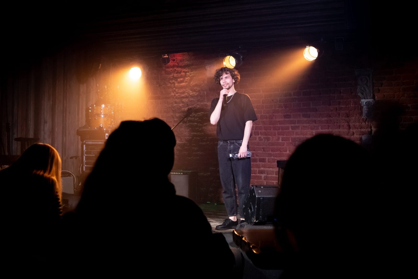 male comedian performing his stand-up monologue on a stage