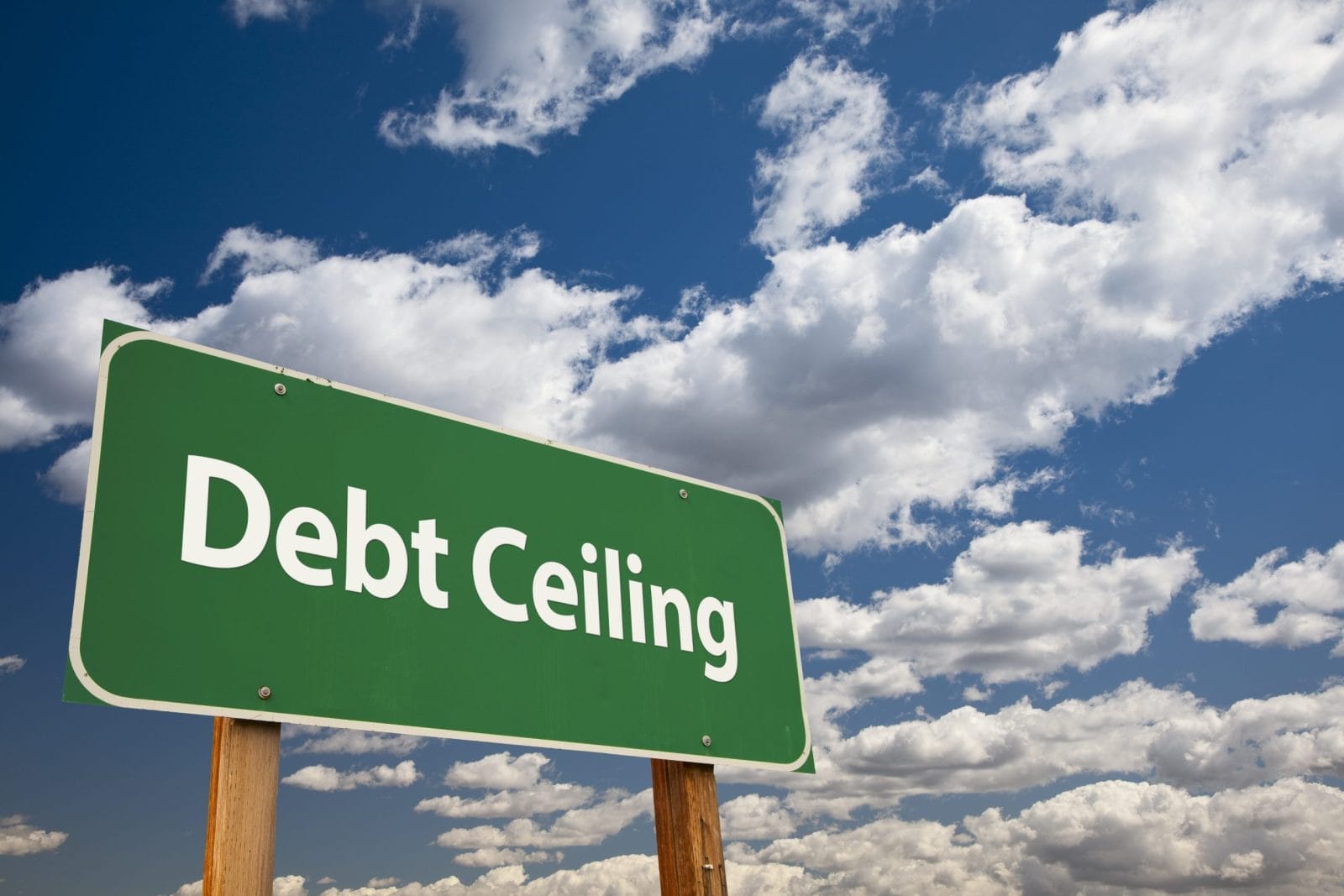 Debt Ceiling Green Road Sign Over Clouds and Sky