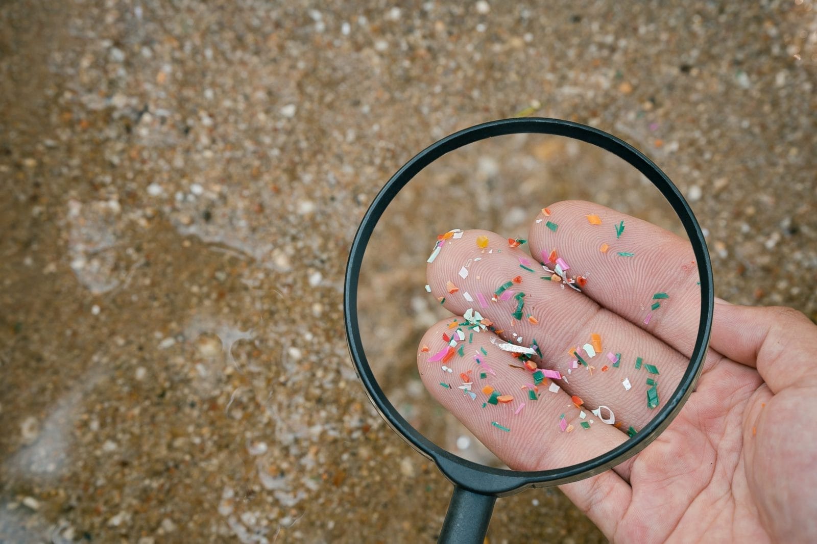 Close up side shot of microplastics lay on people hand