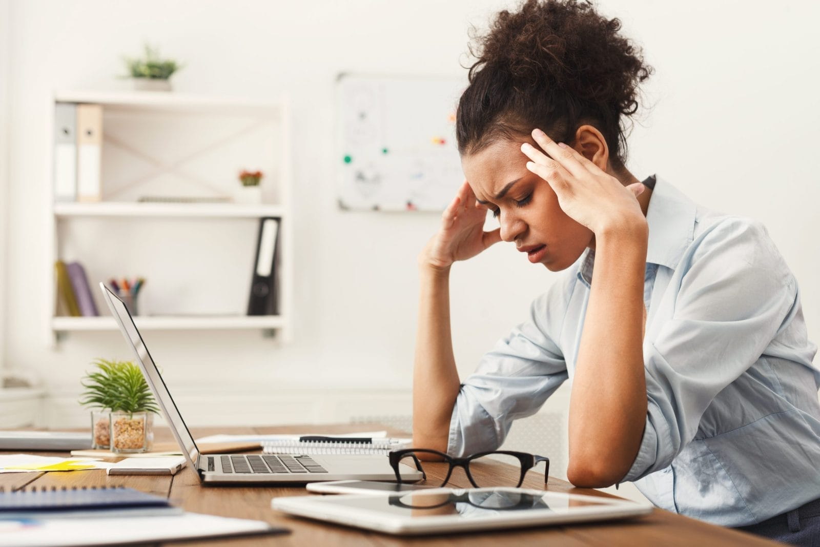 business woman with headache at office