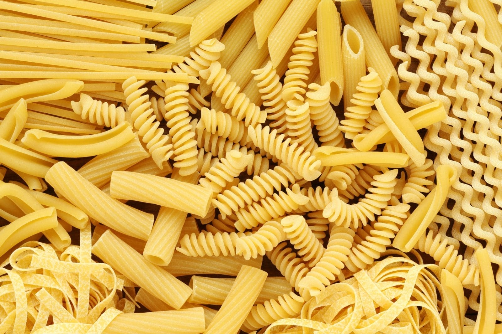 Variety of types and shapes of dry Italian pasta