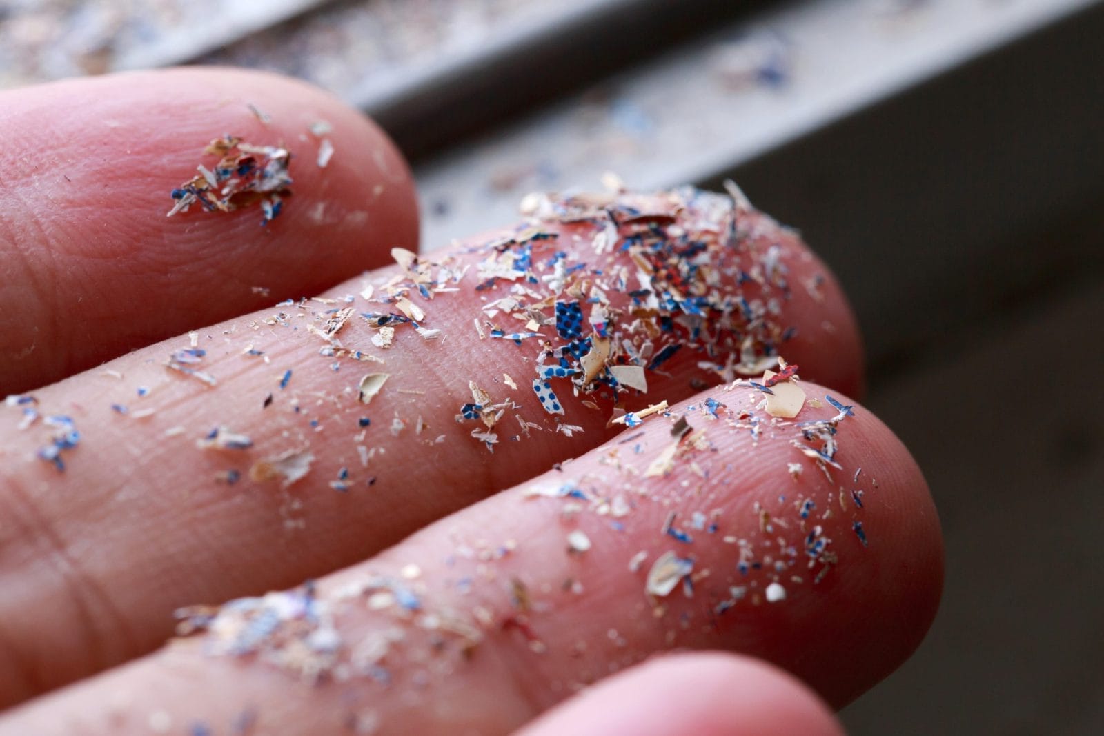 Close up side shot of microplastics lay on people hand