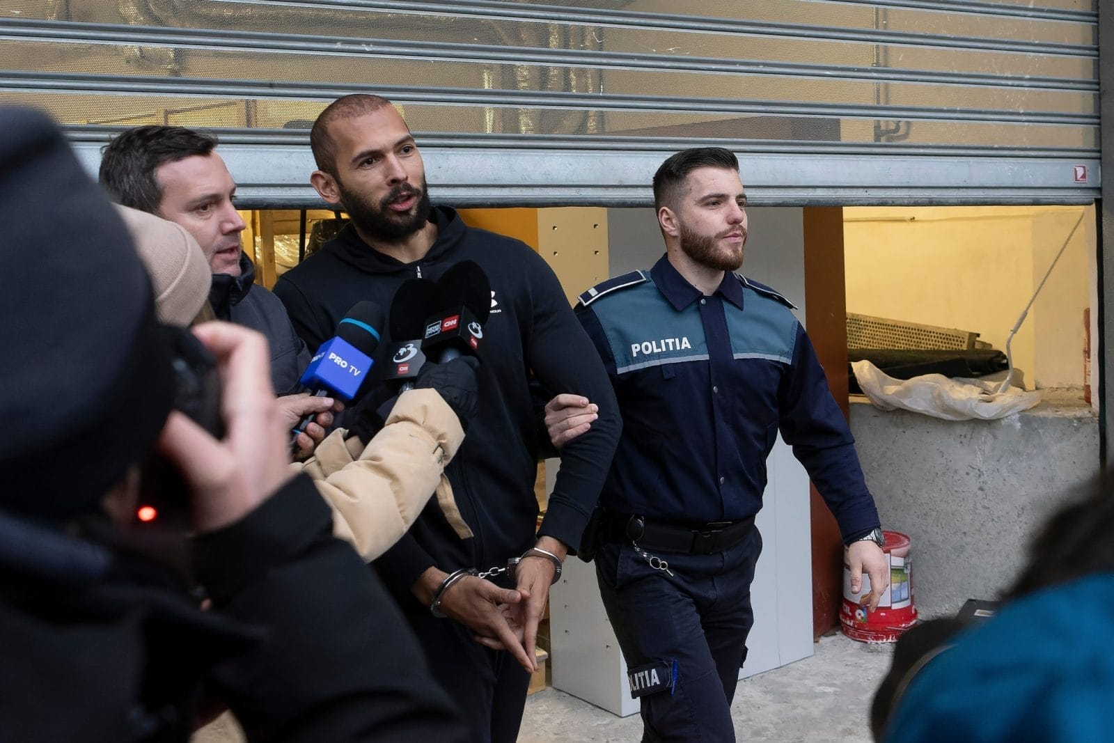 andrew tate in police custody