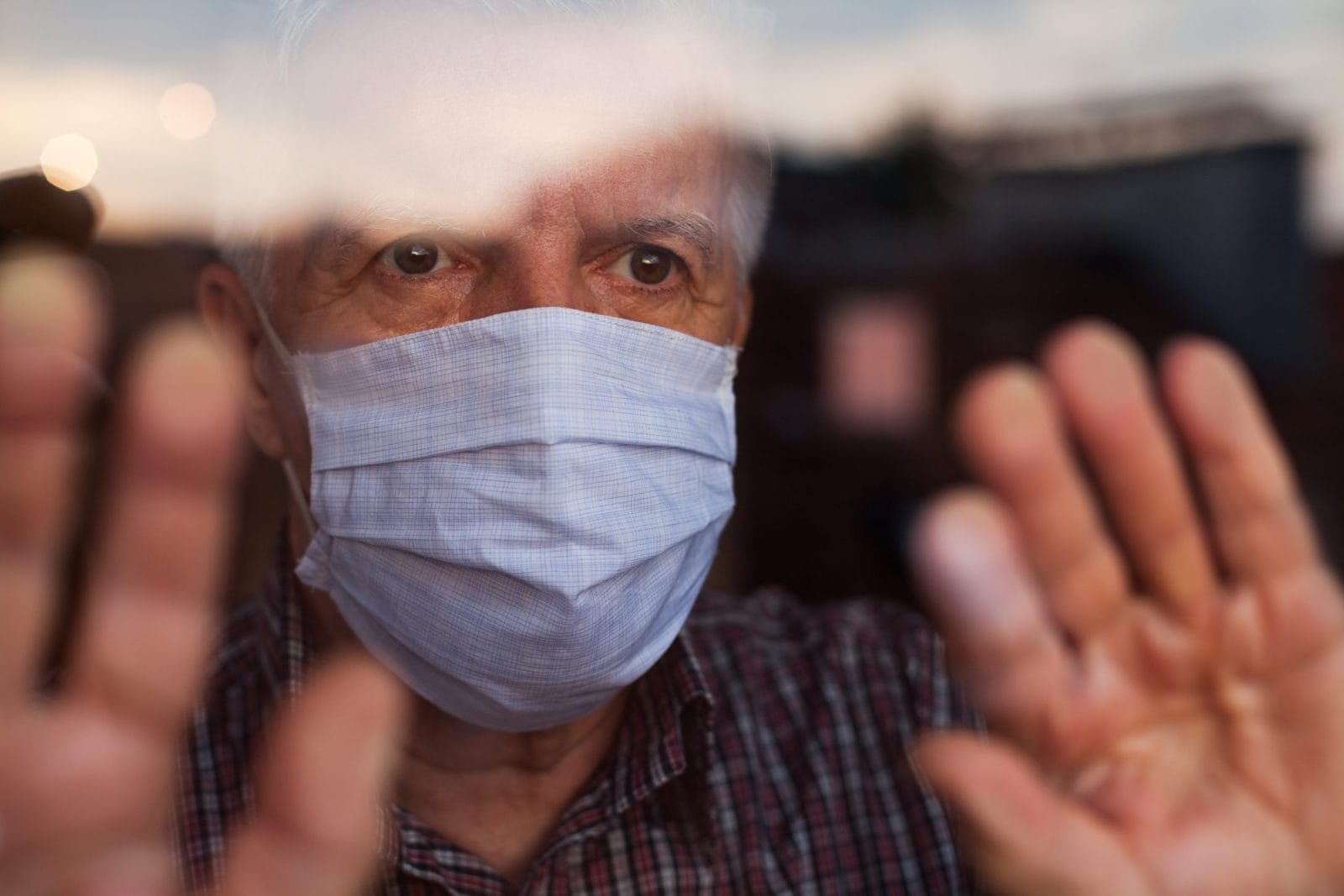 Elderly caucasian man wearing hand made protective face mask