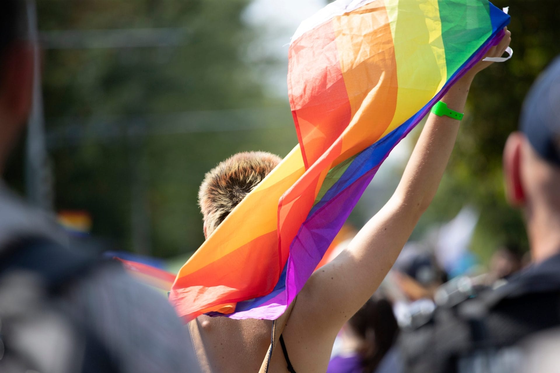 Someone holding a rainbow flag