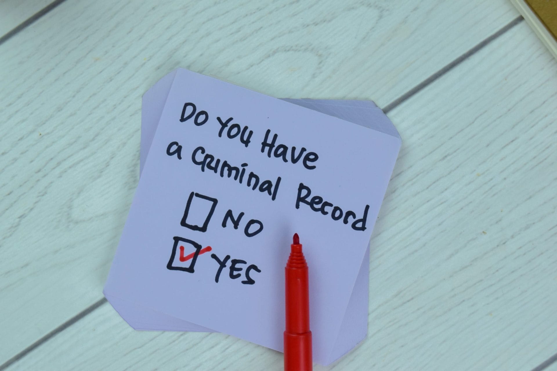 Do you have a criminal record with boxes saying yes or no is written on a post it