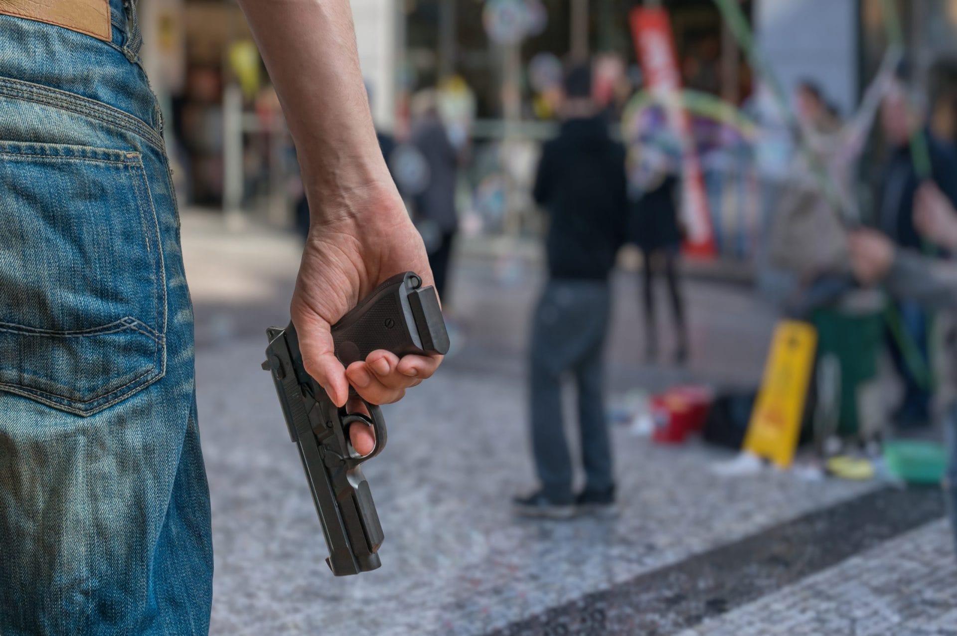 Person holding gun in public space