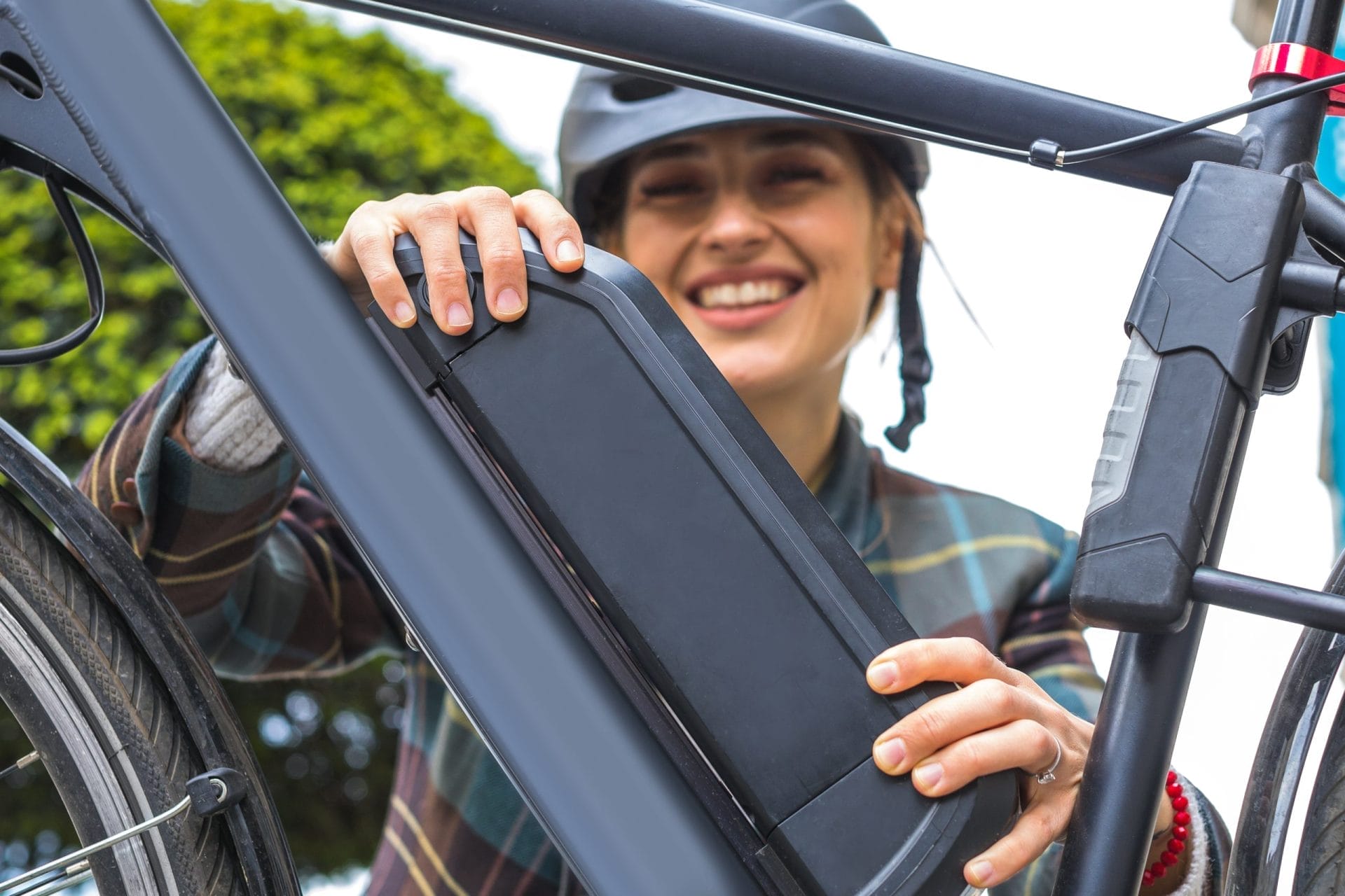 Woman touching battery on E-bike