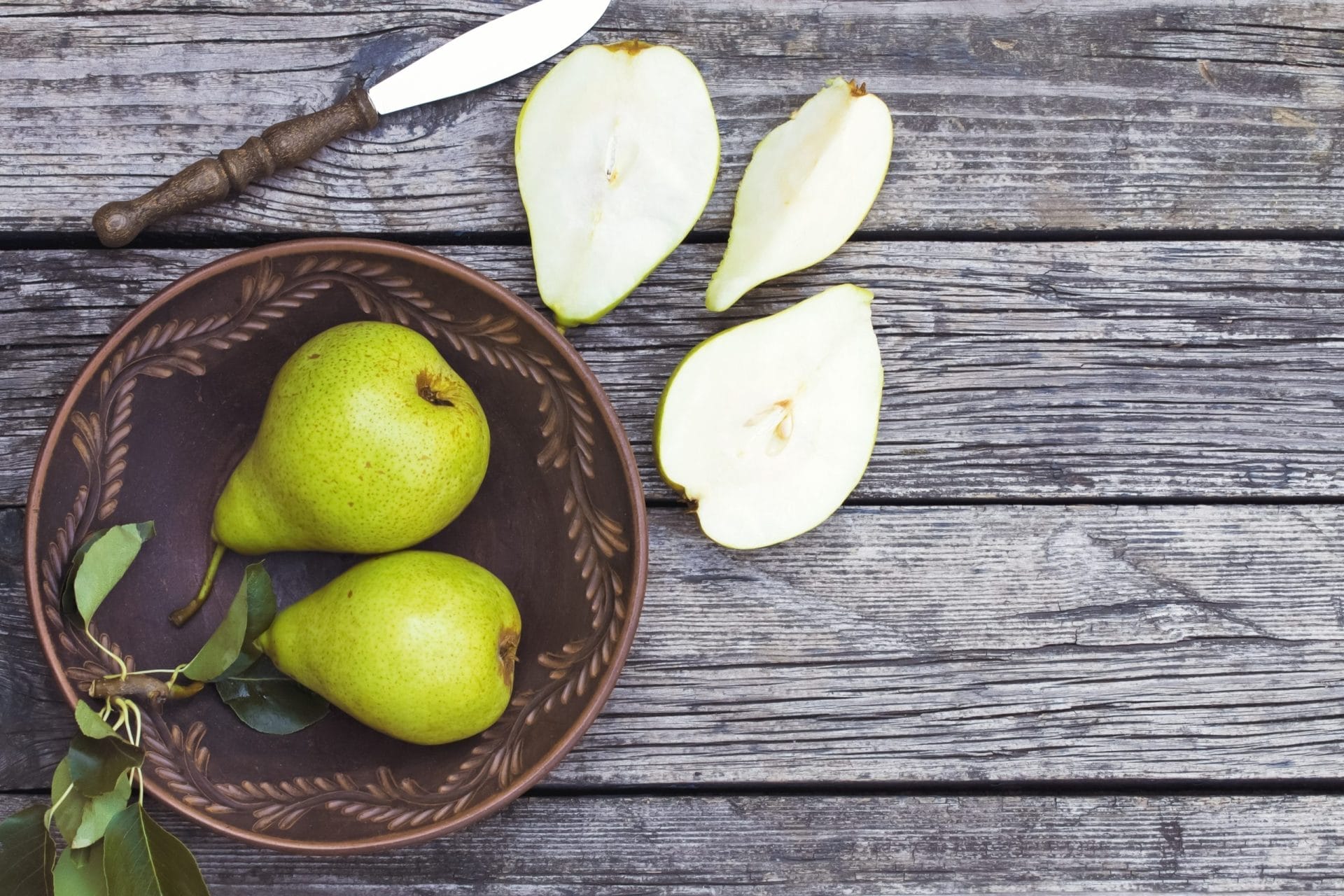 Pears in a plate and sliced in half