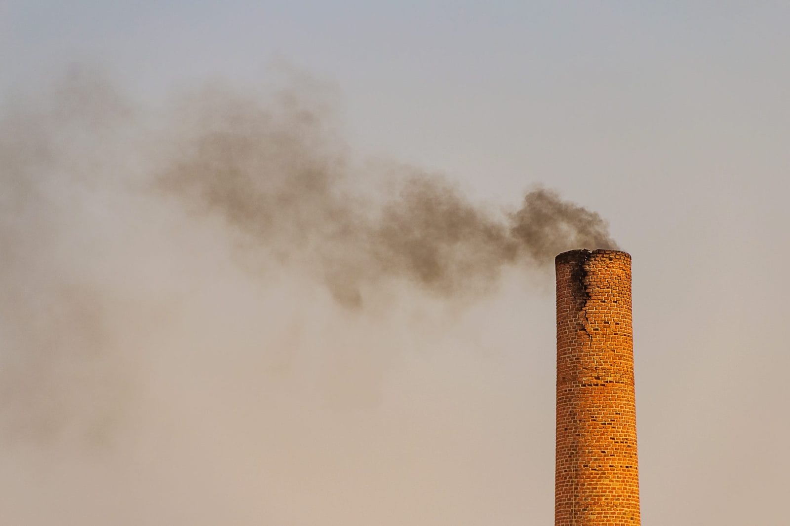 Industrial chimney emitting black smoke