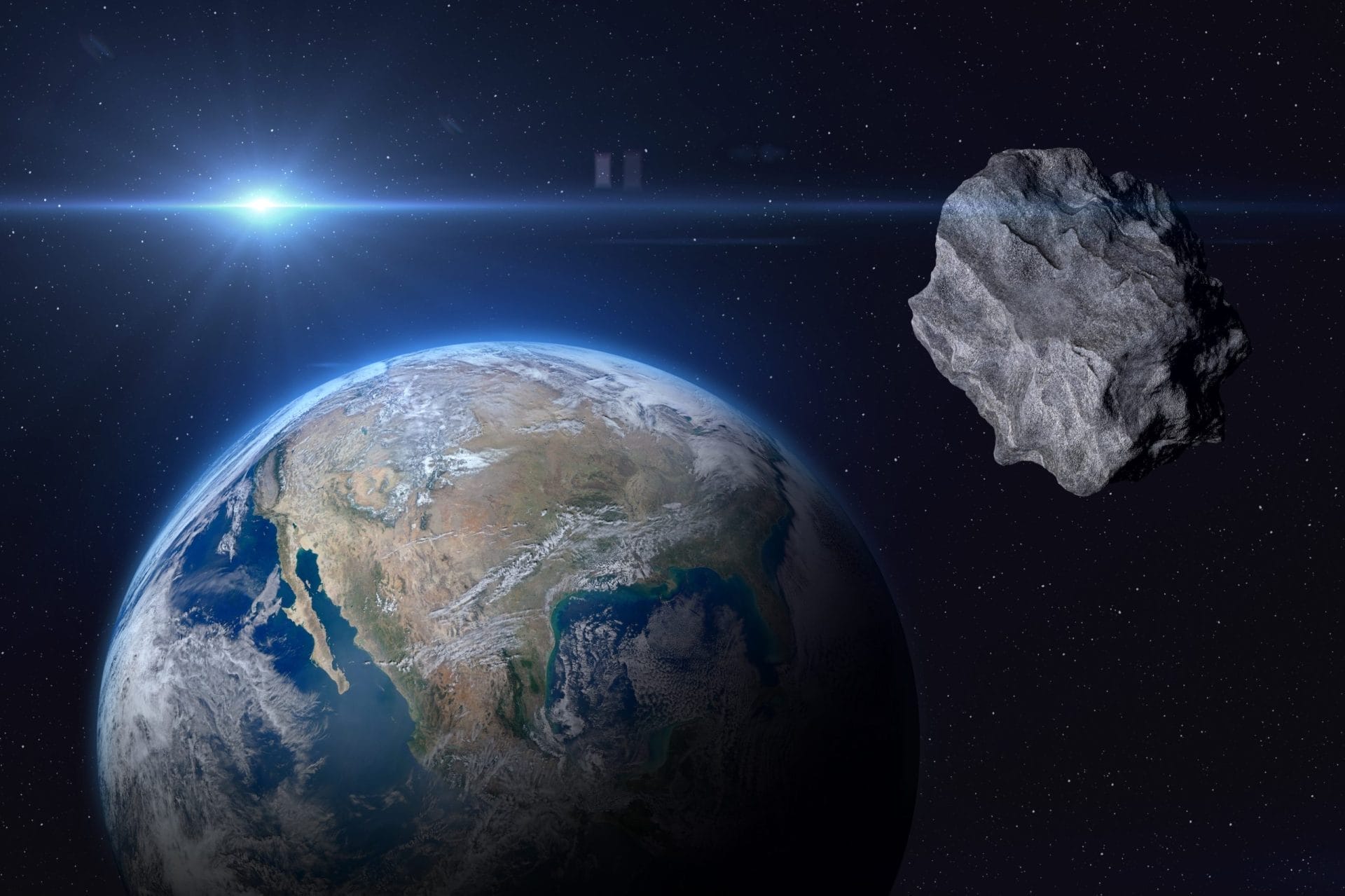 Asteroid and earth in space
