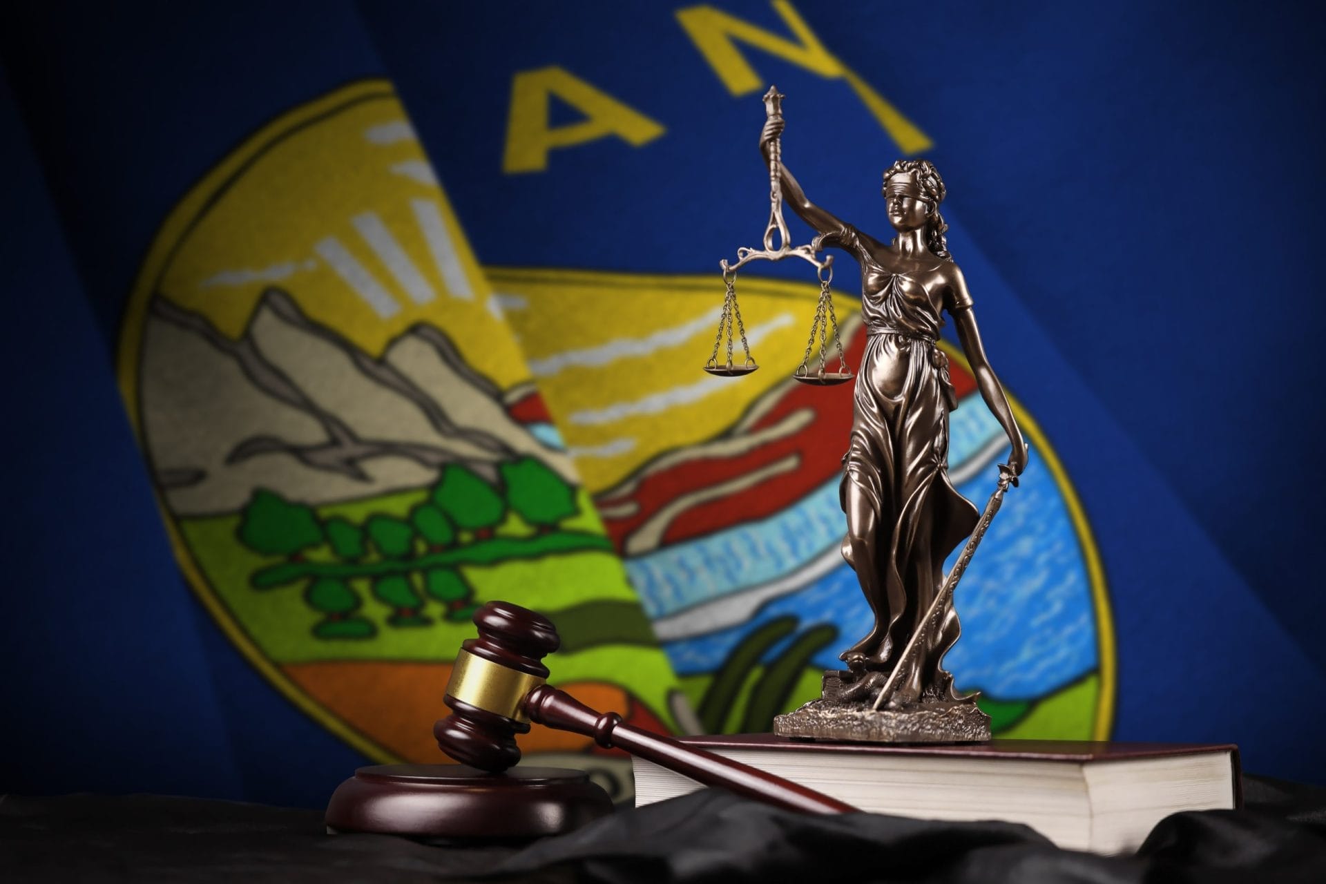 Montana state flag and statue of lady justice