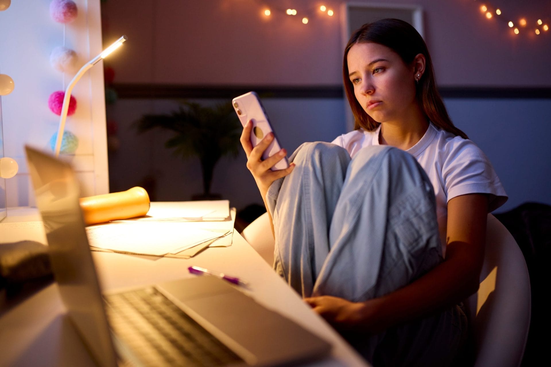 Worried teenage girl looks at her phone