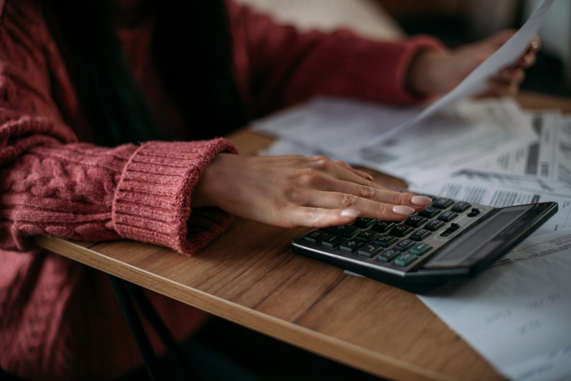 Woman typing on calculator