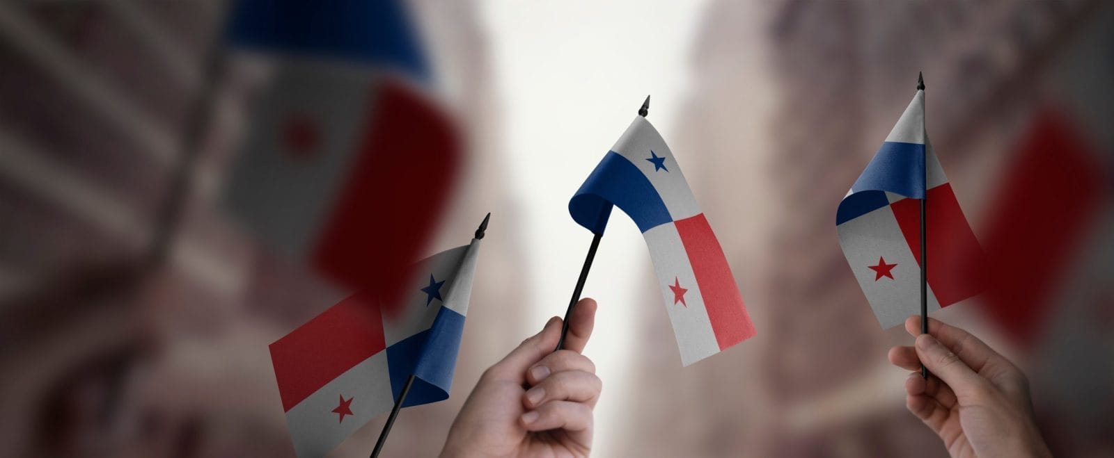 People holding small Panama flags. Panamanian environmental protesters shot and killed.