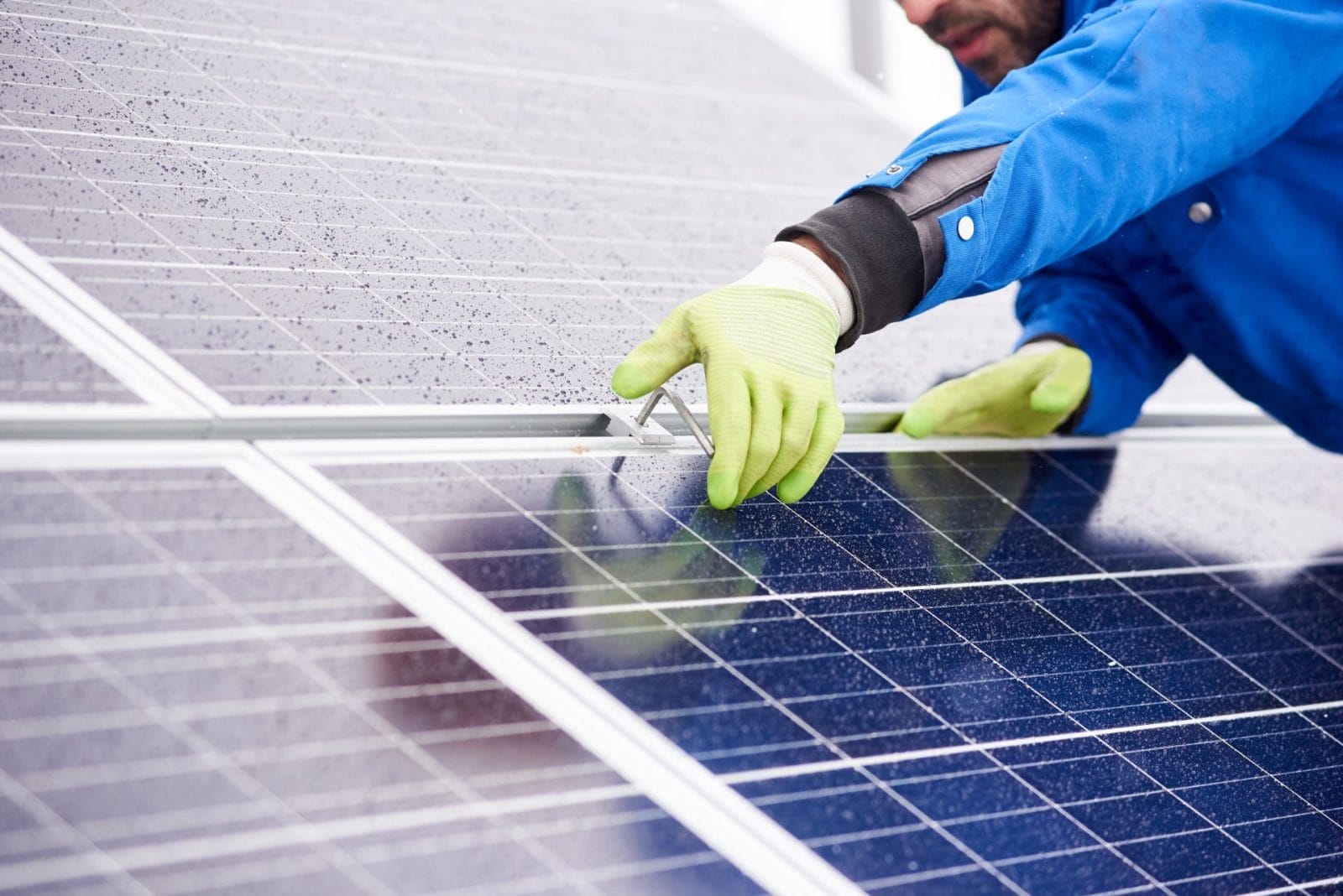 Close-up of man with tools on solar panel