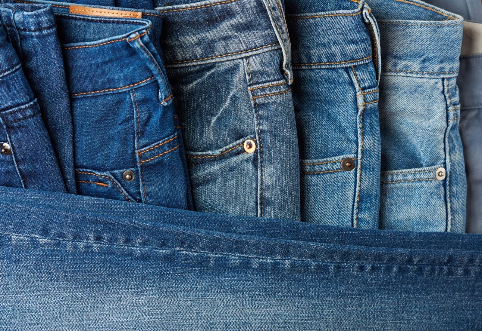Blue jeans pants clothes pile background