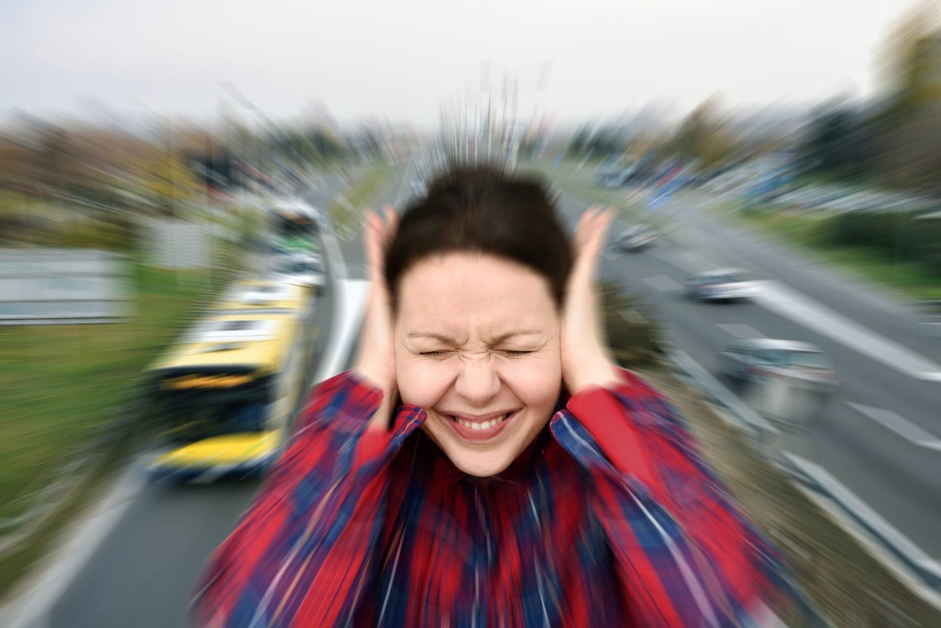 Woman covering her ears and closing her eyes