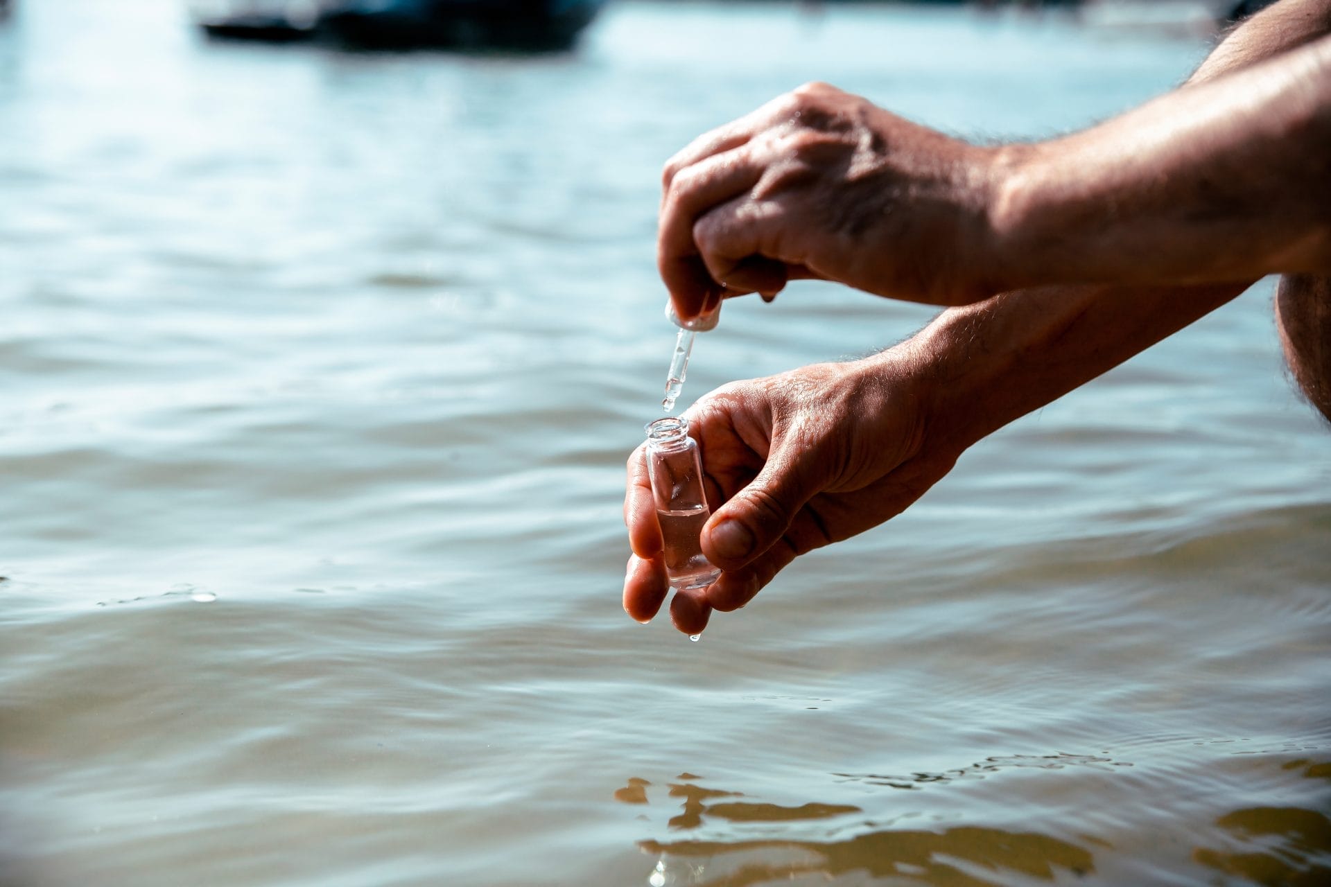 Male hands taking a water sample