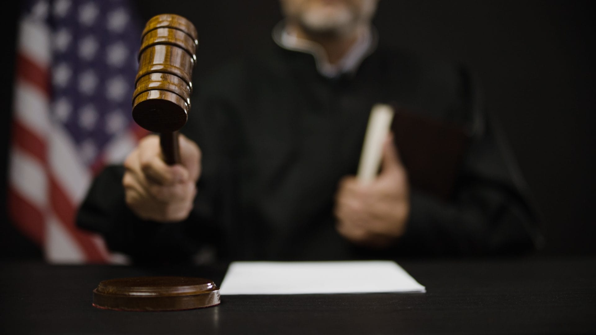 Judge holding gavel in court