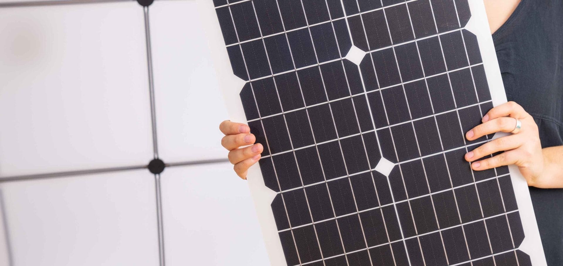 Woman holding flexible solar panels