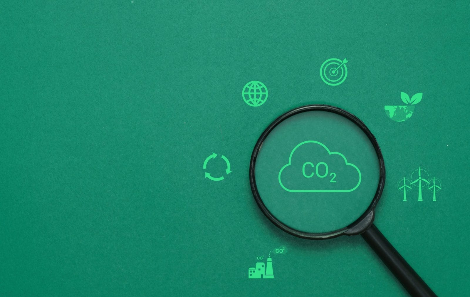 magnifying glass on dark green background with sustainability icons